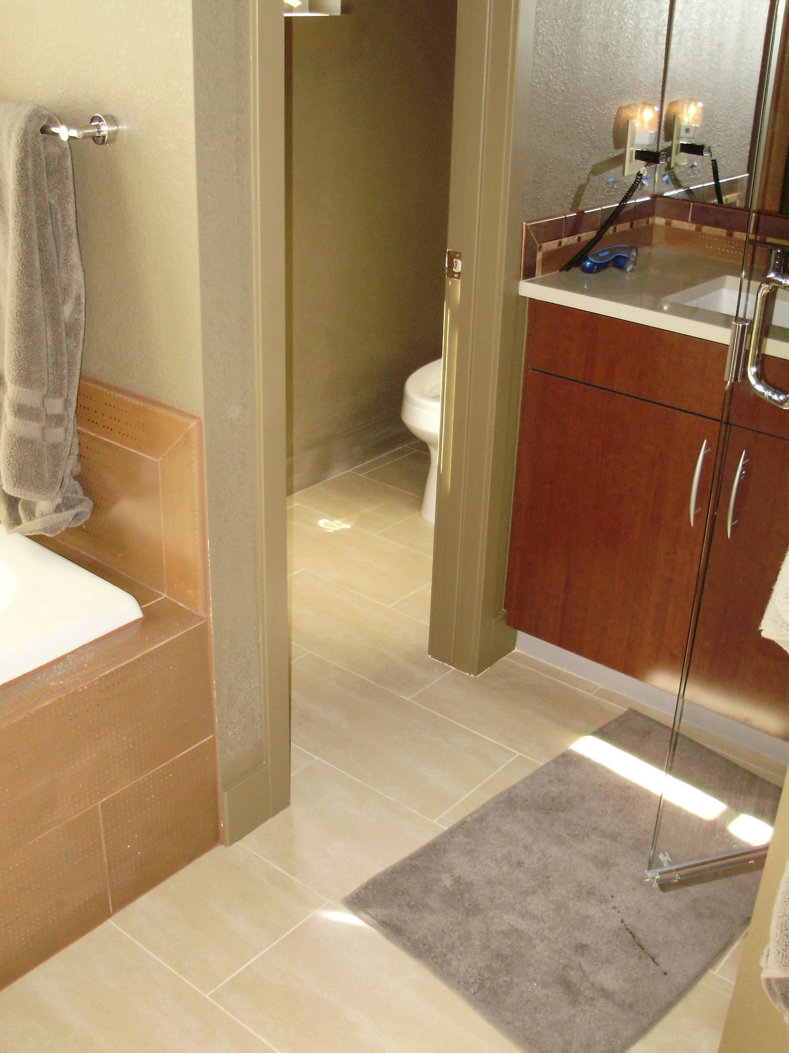 Bathroom remodel with wood vanity and tile floor