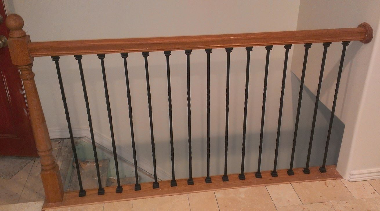 Custom oak stair rail with wrought iron balusters